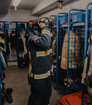 Firefighter suiting up in fire gear